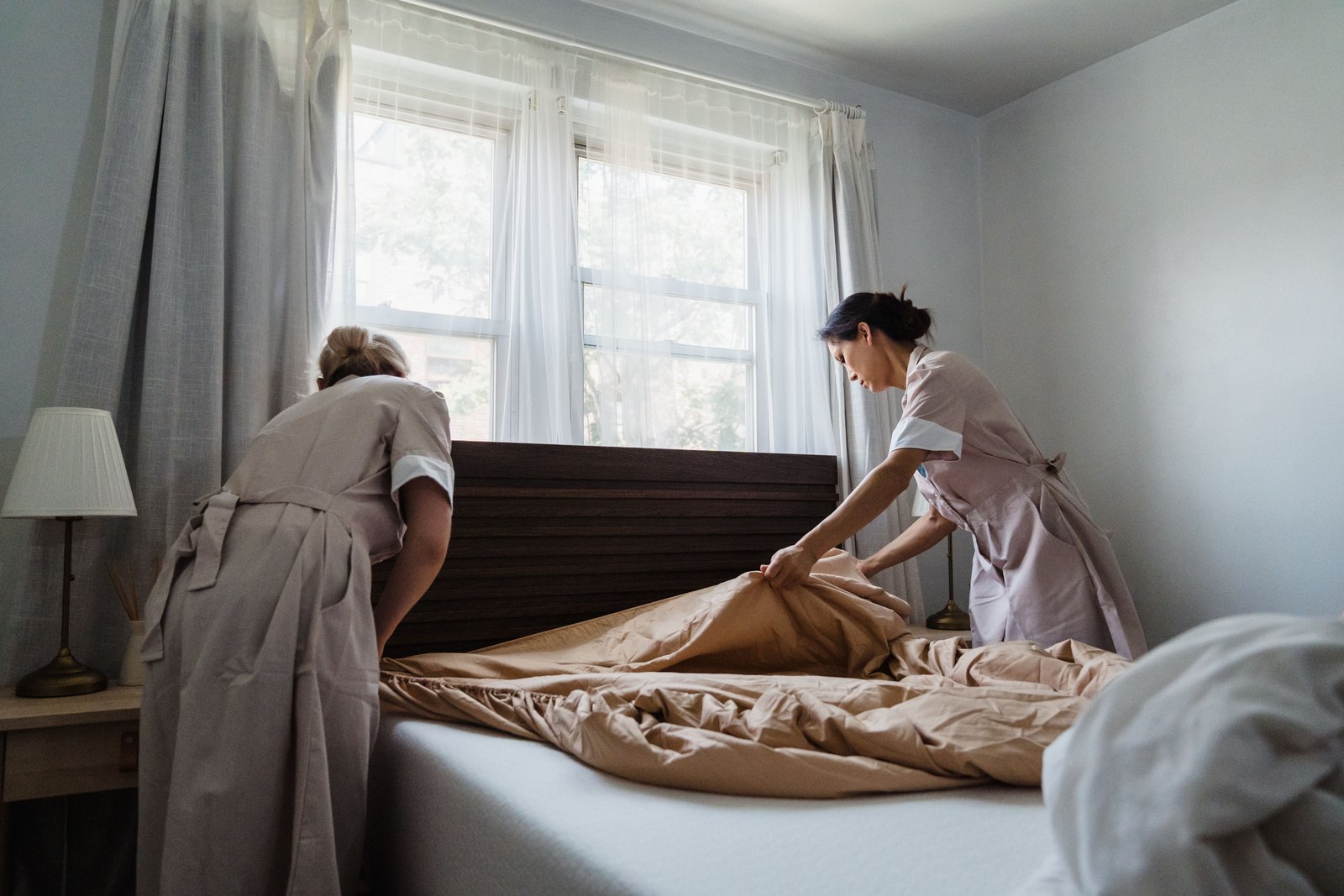 Duqum cleaning team making a bed